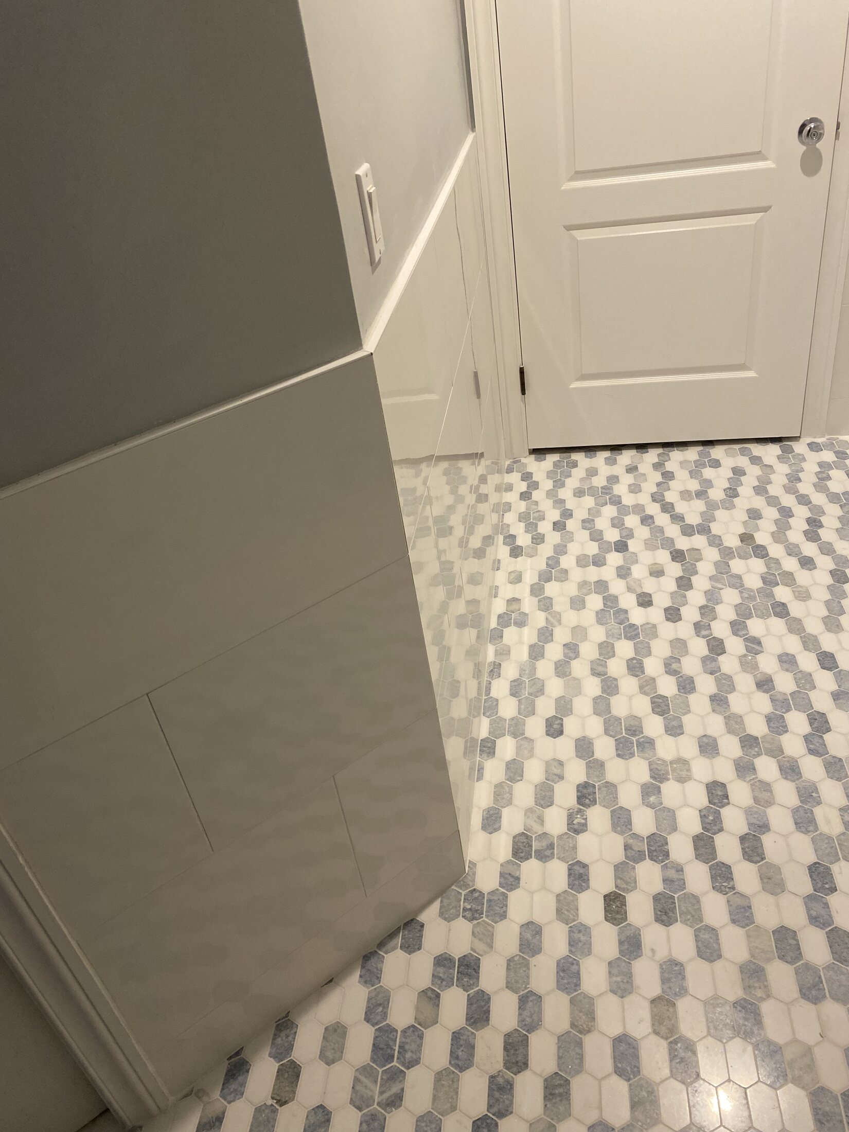Blue-gray and white mosaic tile floor detail