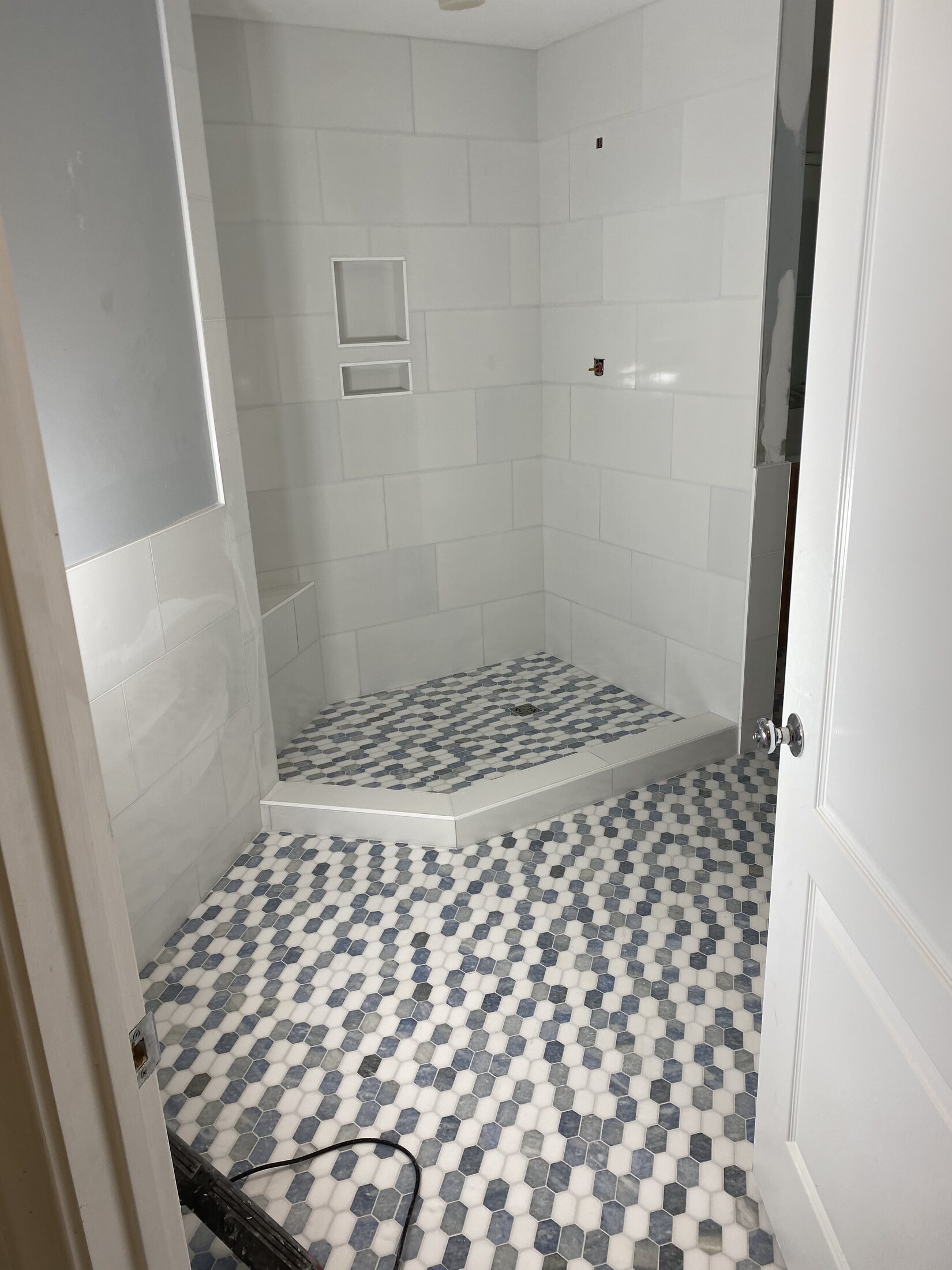 Bathroom with white wall tile and blue-gray hex mosaic floor